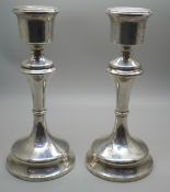 A pair of George V silver candlesticks with weighted bases, Birmingham, 1919, 18cm, 555g total