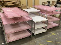 Three pre-owned four tier shop units with shelves on wheels.