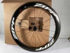 An as new Zipp 404 Carbon Clincher front wheel with an 18-hole count and a black hub.