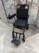 An as new carbon fibre lightweight foldable wheelchair.