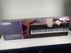 An as new Yamaha portable keyboard (PSR EW320).