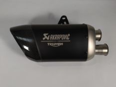 As new Akrapovic titanium slip-on exhaust silencer for Triumph Triple 1200 RS or RR Motorcycle.