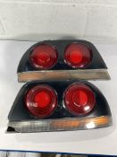 A pair of Nissan Skyline R33 taillights (requires repairing and repainting).
