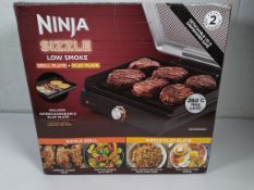 A pre-owned NINJA Sizzle Grill Flat Plate, Low Smoke.