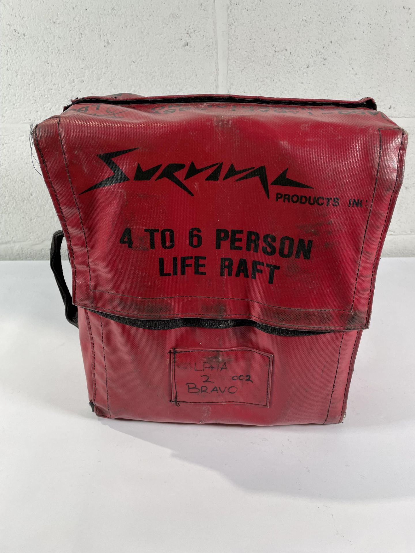 A pre-owned 4 to 6 Person Life Raft (sold as seen).
