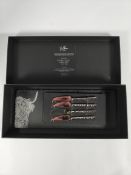 An as new Selbrae Highland Cow set of 4 mini slate cheese boards and knives set, boxed (stock image)