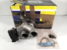 A Garrett remanufactured turbocharger with gasket kit and studs, possible for Mercedes fitment, box