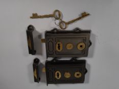 Two pre-owned cast iron and brass Davenport Rim locks and two keys.