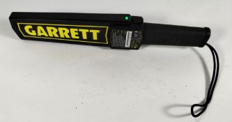 A pre-owned Garrett handheld super scanner / metal detector wand for security screening. (model 1165