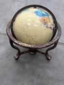 A vintage classic globe with copper effect casing and feet.