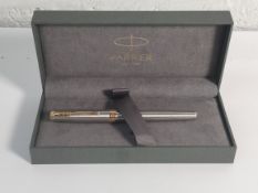 An as new Parker sonnet fountain pen in silver with gold trim (REF: 1934505/3501179315058).