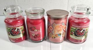 Four as new Yankee candles; two red raspberry 623g single wicks, one capri glow 567g double wick and