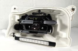 A pre-owned left Hella headlight case and inner unit with power module, unknown fitment, possibly fo