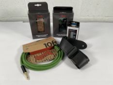 Two Fender Essentials Guitar Wall Hangers (black, walnut), a Fender 100% Hemp Festival Instrument Ca