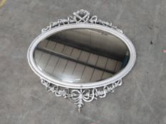 An Antique style oval mirror.