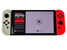 Pre-owned Nintendo Switch OLED Console (HEG-001) with Kirby's Return to Dream Land Deluxe game card.