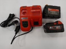 As new Milwaukee rapid charge battery charger with two as new Milwaukee red lithium M18 5.0ah batter