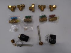 An as new collection of assorted plumbing components including Delta temperature controllers, butter
