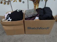 A large quantity of new clothing with tags to include Zara, DKNY (two boxes).