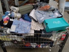 A large basket of assorted new clothing to include footwear, tops, trousers underwaear and related (