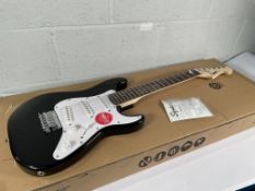 A Squier Mini Stratocaster 3/4 Size, black.