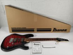 An as new Ibanez GRX70QA-TRB transparent red burst guitar, box opened.