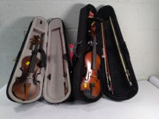 Two pre-owned student violins. TH Mann 3/4 size with case and Givson M200 with case.