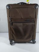 A pre-owned Tumi Gen 4.2 lightweight spinner suitcase.