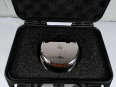 An E2 calibration weight (20kg).