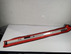 An Tensys metric measuring stick with bag.