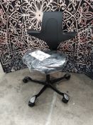 An as new HÅG Capisco Puls 8020 chair ergonomic saddle seat in black.