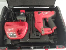 A preowned Milwaukee Fuel FCN18GS-202X 18Ga straight brad nailer with battery and charger.