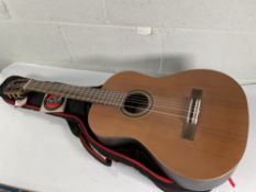 A pre-owned Admira Concerto Classical Guitar (requires a restring) with gig bag.