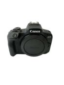 Pre-owned Canon EOS R100 Mirrorless Camera Body with battery & charging dock.