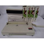 Preowned Opus Atlas 150 Metalbind bookbinding machine, plus a box of assorted unused accessories.