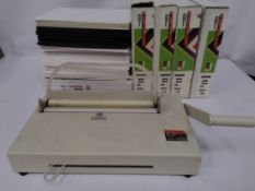 Preowned Opus Atlas 150 Metalbind bookbinding machine, plus a box of assorted unused accessories.