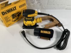 A DeWalt DWE6411 1/4 Sheet Palm Grip Sander 240V (requires a UK power adaptor).