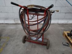 A set of preowned welding tools. One pair of Harris oxygen and acetylene hoses with dual guages, one