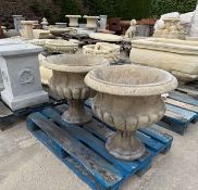 PAIR OF SOLID LIMESTONE RECONSTITUTED ANTIQUED URNS ON PALLET