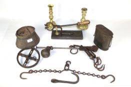 A collection of antique metal ware including table sugar cutter, steelyard, baking tin, candlesticks