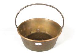 A brass jam pan with loop handle