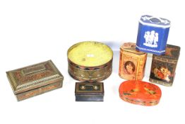 An antique tea tin in the shape of a drum and six various other tins