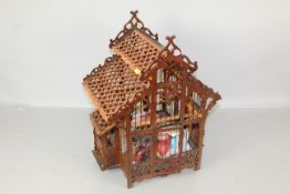 A fretwork bird cage and antique bird feeder