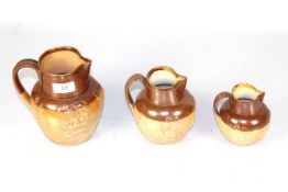 A set of three graduated late Victorian harvest jugs, the largest marked Stiffe & Co