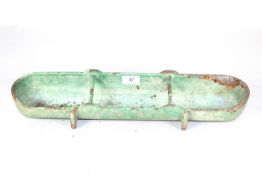 A small cast iron feed trough