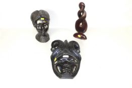 An ebony Nigerian tribal bust and face mask, dating from the 1950s, Colonial Nigeria and a carved
