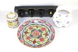 A large decorative plate, biscuit barrel, vase and a quantity of mugs