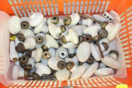 A large quantity of antique French ceramic and brass door knobs