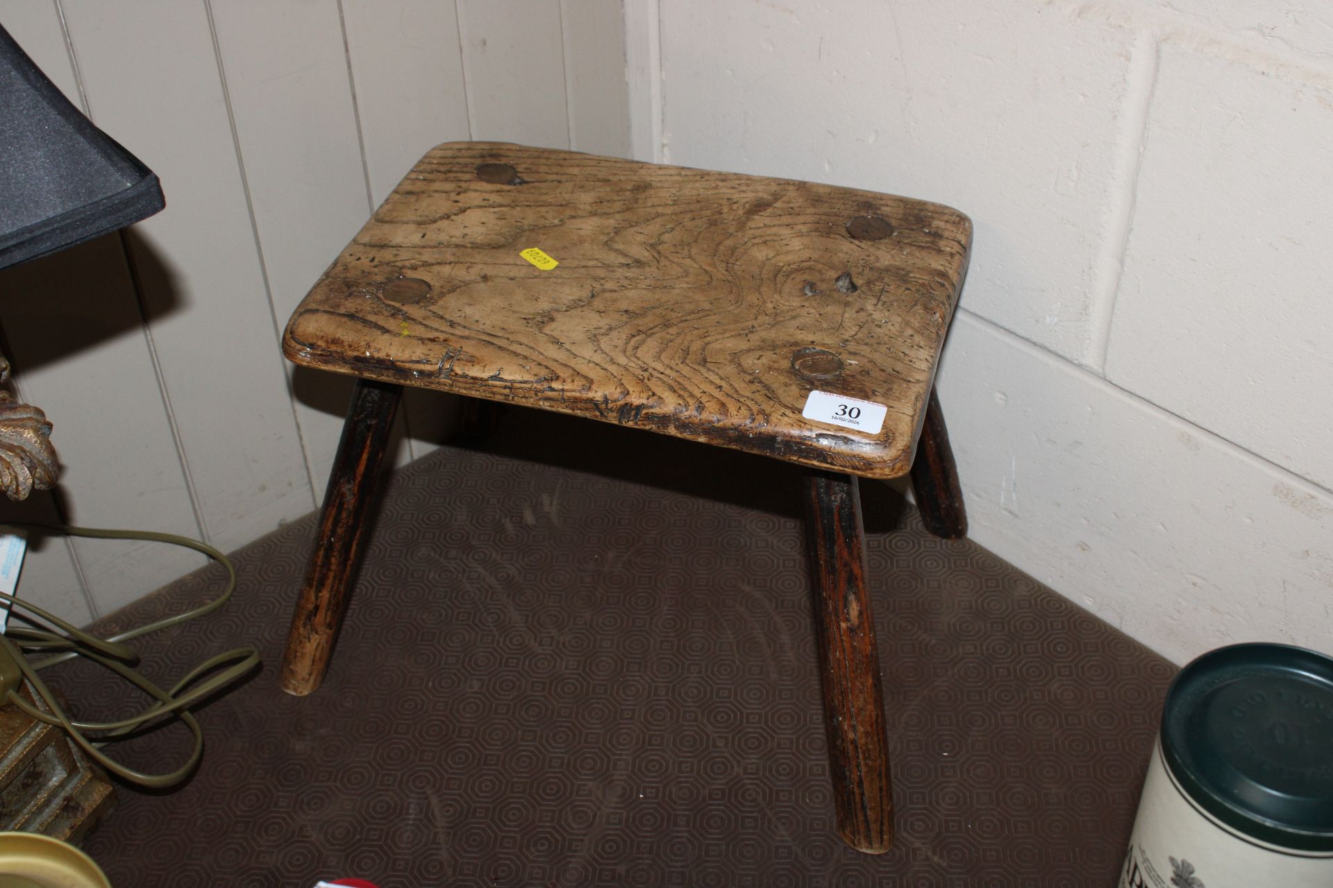 A rustic elm seated stool