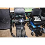 A GoGo mobility scooter with battery charger, lack